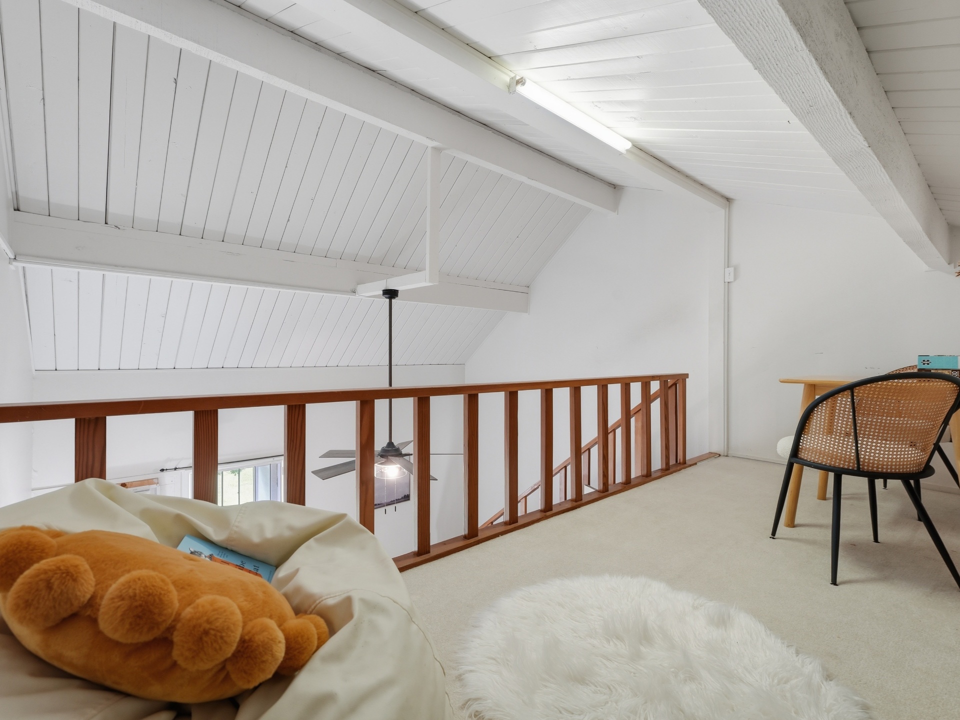 Loft overlooking primary bedroom with vaulted ceilings