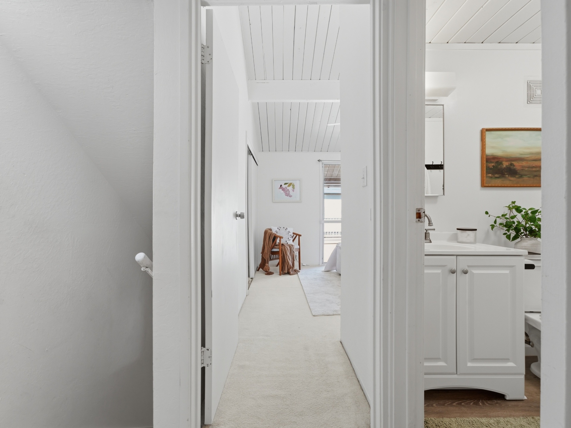 Hallway view to bedroom with adjacent full bathroom