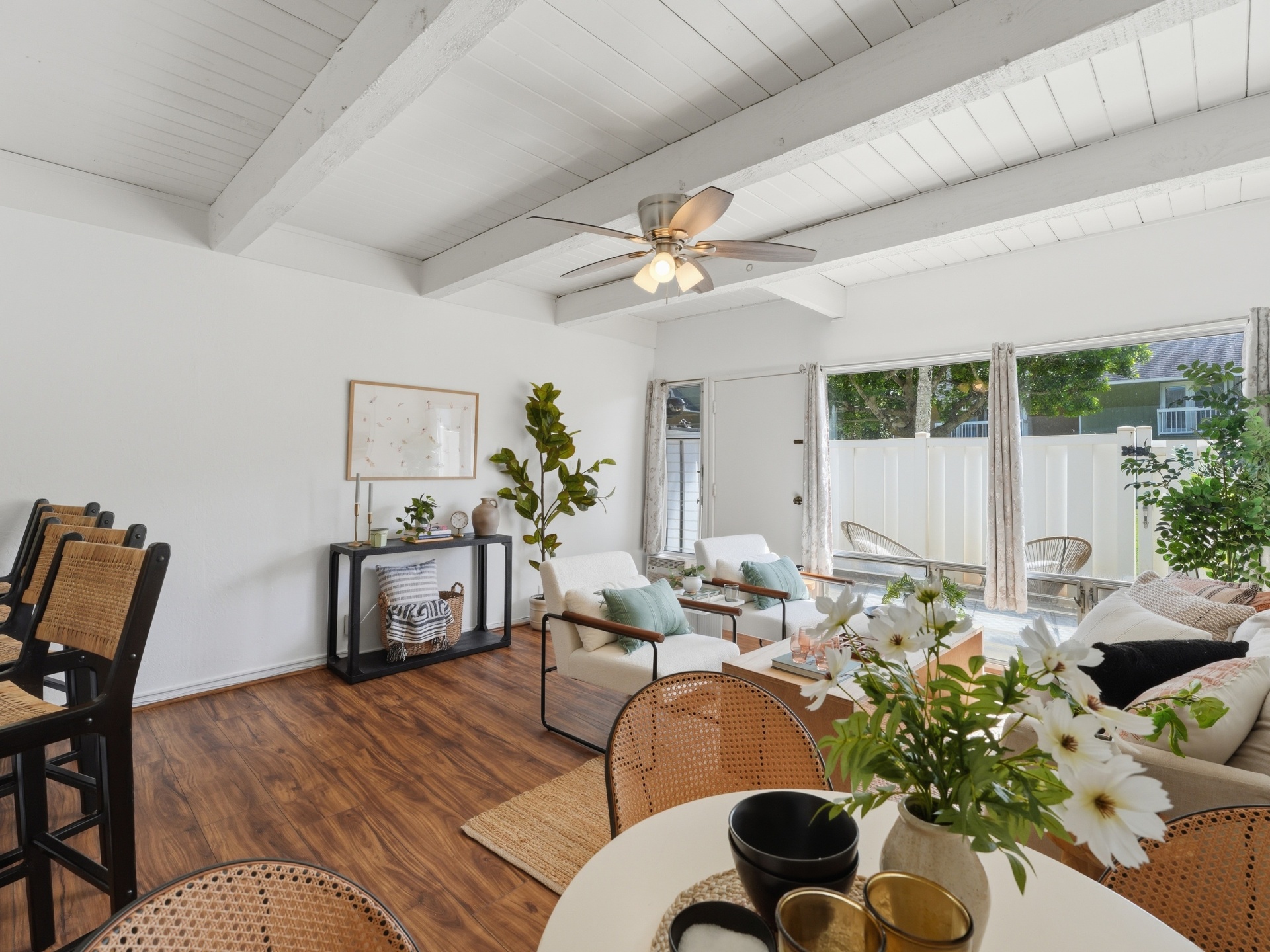 Living area with console table and large windows to courtyard