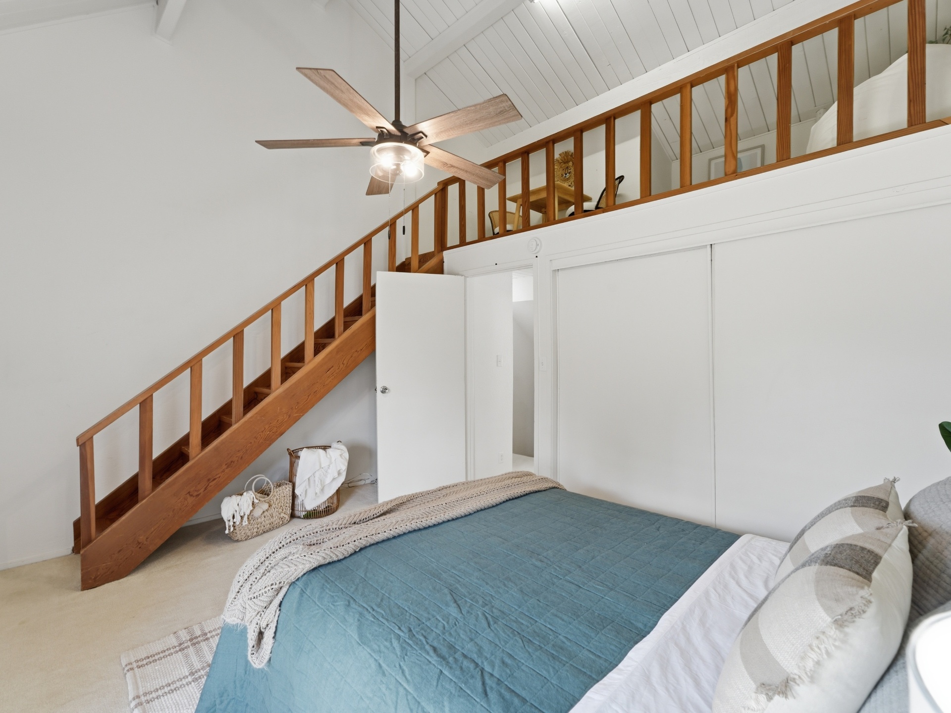 Primary bedroom showing staircase up to the finished loft